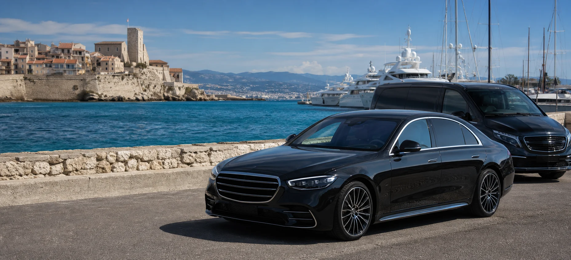 Luxury Mercedes-style chauffeur fleet beside Port Vauban in Antibes